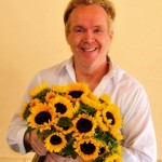 Mike Gaffney, flower designer, holding sunflowers