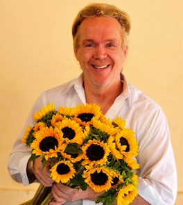 MIke Gaffney, flower designer, holding sunflowers