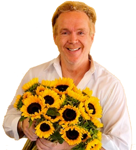 MIke Gaffney, flower designer, holding sunflowers